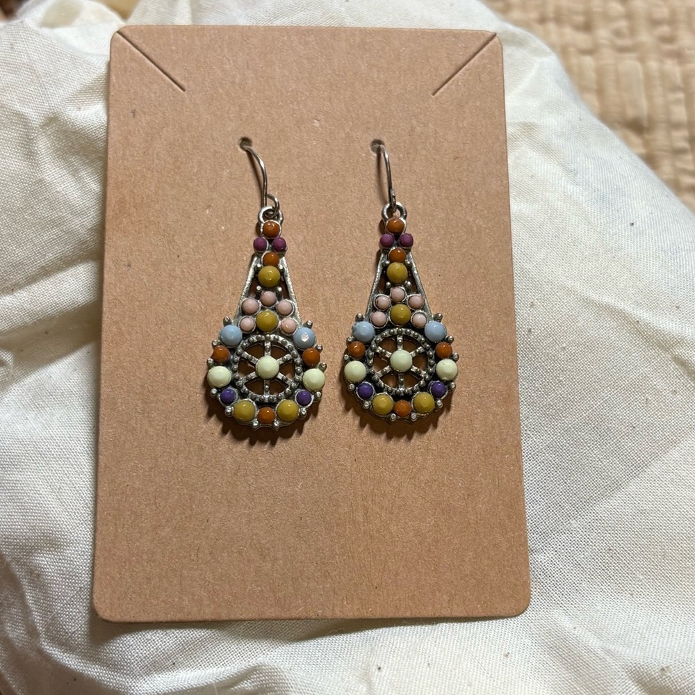 Beautiful muted mosaic dot art style drop earrings in a silver tone setting.